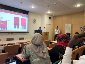 Izzy and John present research data at a conference
